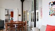 Seville Apartment - The living room has a sofa, TV and dining table with 6 chairs.