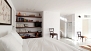 Sevilla Apartamento - Sleeping area with a bookshelf and TV.