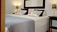 Seville Apartment - Comfortable bedroom with two twin beds placed together.