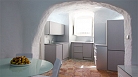 Granada Apartment - Dining table with the kitchen beyond.