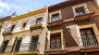 Sevilla Apartamento - House facade on the right.