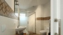 Séville Appartement - Bathroom with a walk-in shower. The washing machine is inside the bathroom.