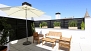 Séville Appartement - Terrace with outdoor seating and parasol.