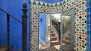 Seville Apartment - Outdoor mirror with ceramic tiles. Stairs lead up to the roof-terrace.