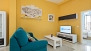 Sevilla Apartamento - Living area with a sofa, coffee table and TV.