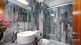 Sevilla Ferienwohnung - Marble-lined bathroom with shower.