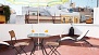 Séville Appartement - Charming terrace with table, chairs and deck chairs.