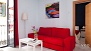 Sevilla Apartamento - Bright living room with a large window. The master bedroom is just seen beyond.