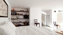 Seville Apartment - Sleeping area with a bookshelf and TV.