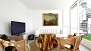 Sevilla Apartamento - The living area is furnished with a sofa, table, 2 armchairs and TV.