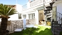 Seville Apartment - Lower terrace with table and chairs. Circular stairs lead up to the roof-top.