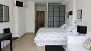 Seville Apartment - The sleeping area has twin beds placed together and a large wardrobe.