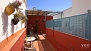 Séville Appartement - Private terrace equipped with outdoor seating and plants.