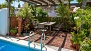 Sevilla Apartamento - Terrace pool with garden furniture and plants.