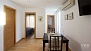 Seville Apartment - Extendable dining table and chairs. The door on the left is to the bathroom.