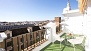 Sevilla Apartamento - The terrace is equipped with outdoor furniture and a sun canopy.
