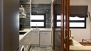 Sevilla Apartamento - Sliding glass doors separate the kitchen and living room.