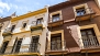 Seville Apartment - House facade on the right.