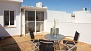 Séville Appartement - Terrace with table and chairs.