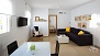 Seville Apartment - Living room with dining table, chairs and sofa. 