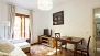 Seville Apartment - Living room with sofa and flat-screen TV.