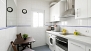 Séville Appartement - The kitchen includes a small table and 2 chairs.