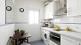 Seville Apartment - The kitchen includes a small table and 2 chairs.