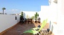 Sevilla Ferienwohnung - Terrace with deckchairs, table and chairs.