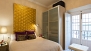 Sevilla Apartamento - Bedroom with double bed and wardrobe. The window faces a small pedestrian alley.
