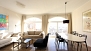 Sevilla Apartamento - Open-spaced living area with 2 large windows.