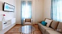 Seville Apartment - Living room with sofa-bed, coffee table, armchair and TV.