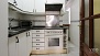 Séville Appartement - Kitchen equipped with all main appliances: oven, washing machine and tumble dryer.