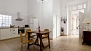 Seville Apartment - Dining area and kitchen. The bathroom is next to the entrance (door to the left).