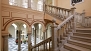 Seville Apartment - Patio of the house with a colonnade of arches and a central fountain.