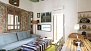 Seville Apartment - The living room is furnished with a large sofa, 3 armchairs, central table and TV.