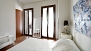 Sevilla Apartamento - Bedroom 1 has 2 windows facing a quiet central patio.