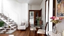 Séville Appartement - View to the dining area with a table and 3 chairs. Beyond is the kitchen.