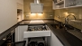 Seville Apartment - Kitchen equipped with microwave-oven, washing machine, fridge-freezer and stove.