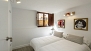 Sevilla Apartamento - Bedroom 1 with twin beds. The window faces calle Escoberos.