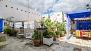 Seville Apartment - Private terrace decorated and equipped with plants, outdoor furniture and pergola with a dining table.