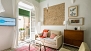 Seville Apartment - Living area with a sofa, coffee table and TV.