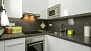 Sevilla Apartamento - Kitchen. Main appliances include an oven, dishwasher and washing-machine.