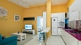 Seville Apartment - The kitchen is partially separated from the living area by a breakfast bar, and includes two bar stools