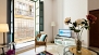 Seville Apartment - Living area. A large window opens out into a small balcony.