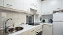 Seville Apartment - Kitchen with oven and washing machine.