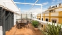 Seville Apartment - Terrace with outdoor furniture and plants.