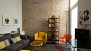 Seville Apartment - Living room with a sofa, armchair and TV.