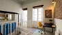 Séville Appartement - The apartment features high ceilings, exposed brick walls and traditional floor tiles.