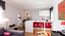 Seville Apartment - Living room and open-plan kitchen with breakfast bar.