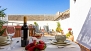 Seville Apartment - Terrace with a pergola and table for dining.